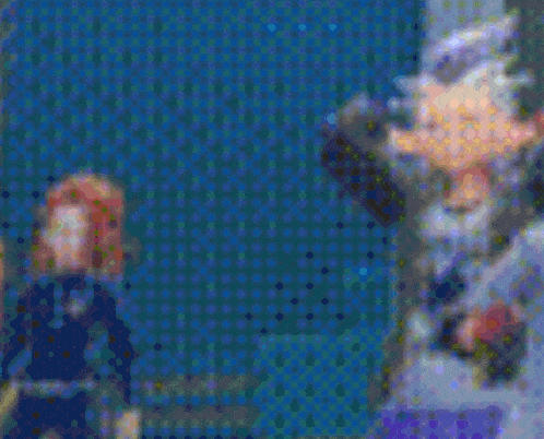 a blurry picture of a man and a woman holding a bat