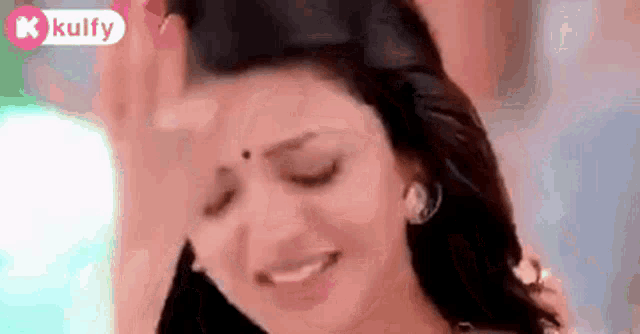 a close up of a woman 's face with her eyes closed .