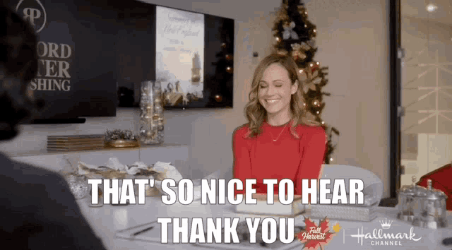 a woman sitting at a table with the words that so nice to hear thank you on the bottom