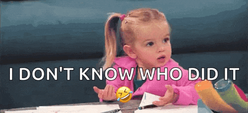 a little girl is sitting at a table with a smiley face and the words `` i don 't know who did it ''