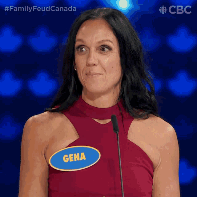 a woman with a name tag that says gena stands in front of a microphone