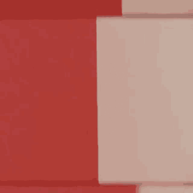 a close up of a red and white striped wall with a white square in the middle .