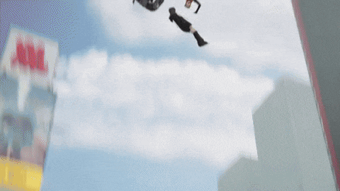 a person is flying through the air in front of a building that has the word dhl on it