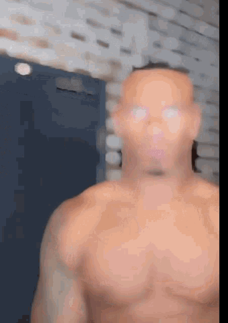 a blurred image of a shirtless man standing in front of a door