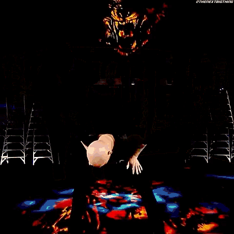 a man is doing a trick on a stage while standing on a green table .