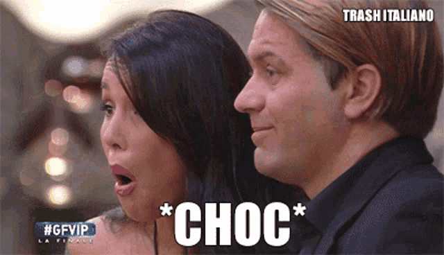 a man and a woman are standing next to each other and the word choc is visible