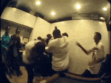 a group of people are dancing in a room in a house .