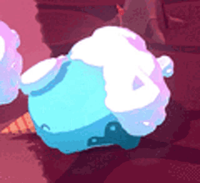 a cartoon character is sitting on a rock with a candy cone on it .