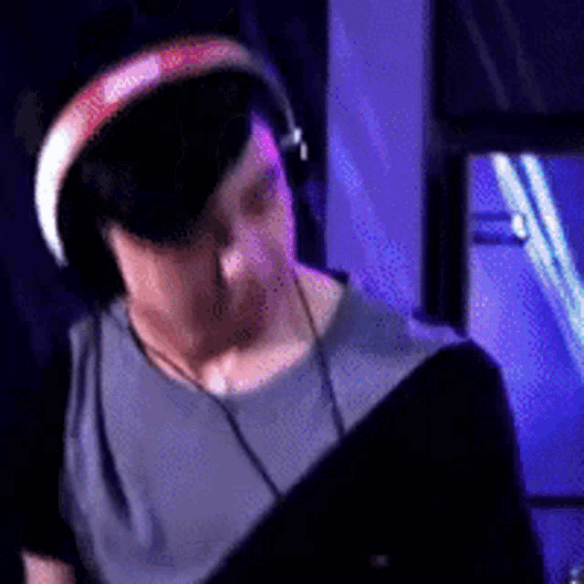 a man wearing headphones and a grey shirt