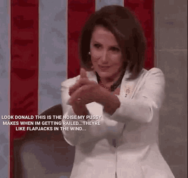 a woman in a white jacket is clapping her hands in front of a red white and blue american flag .