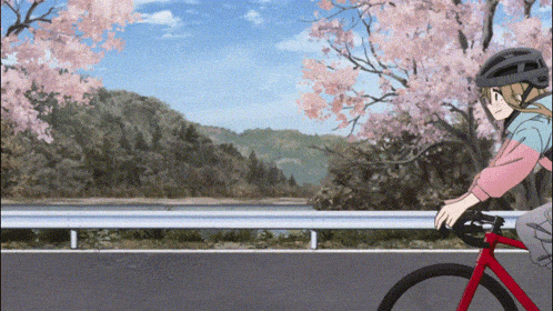 a person is riding a bike down a road