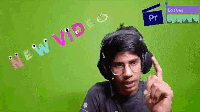 a man wearing headphones is pointing at something in front of a green background that says " new video "