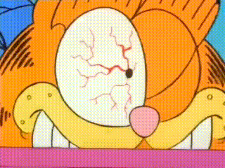 a close up of garfield 's face with a bloody eye .