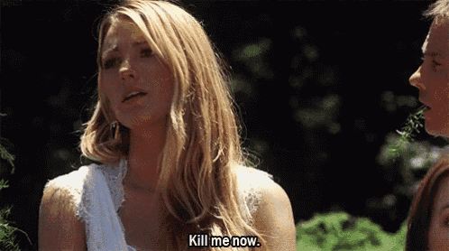 a woman in a white dress is talking to another woman and saying kill me now .