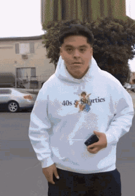 a man wearing a white hoodie with the words 40s & shorties on it
