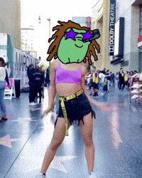 a woman in a purple top and black shorts stands in front of a dolby theatre sign