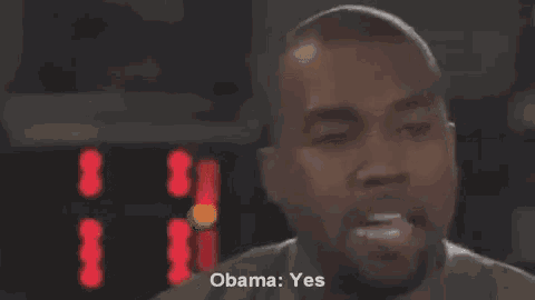 a man with a beard is talking into a microphone and says `` obama : yes '' .
