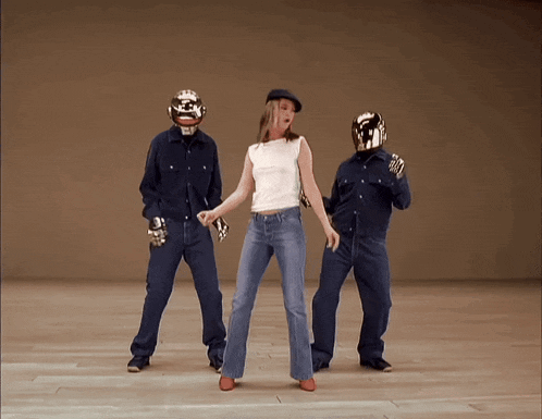 a woman in a white top is dancing with two men in blue shirts