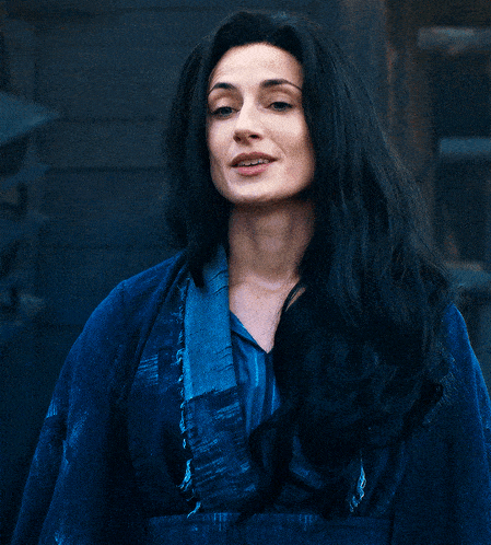 a woman with long black hair is wearing a blue robe
