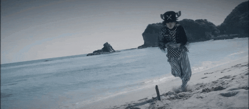 a black and white photo of a person on a beach with chinese writing