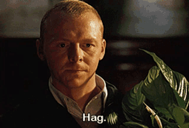 a man holding a plant with the word hag written on his face