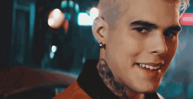 a close up of a man 's face with a tattoo on his neck