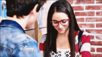 a boy and a girl are looking at each other and the girl is wearing glasses and a disney channel logo