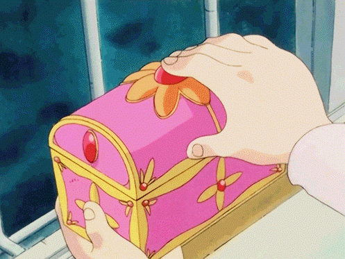 a person holding a pink box with a flower on it