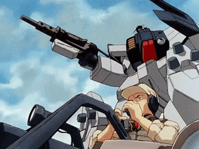 a man is sitting in the cockpit of a robot with a gun in his hand