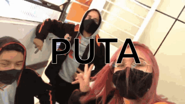 a group of people wearing face masks are posing for a picture with the word puta in the upper right corner