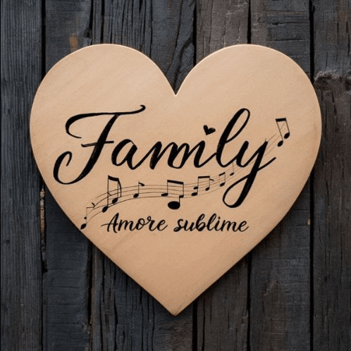 a wooden heart with the words family amore sublime written on it