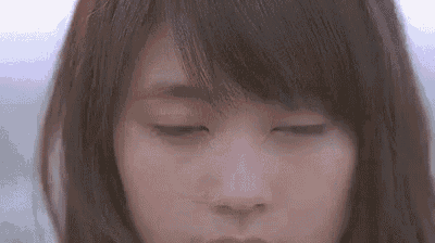 a close up of a woman with her eyes closed and her mouth open .
