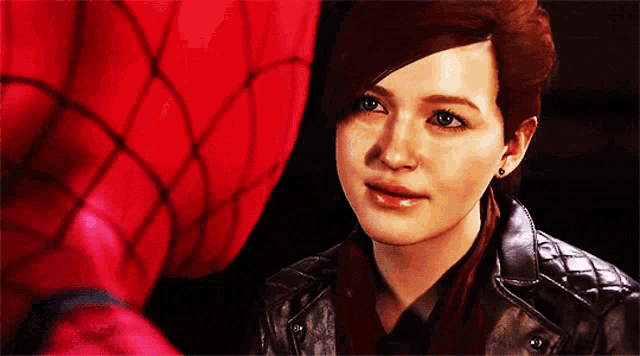 a woman in a leather jacket stands next to a spider-man