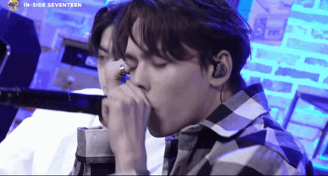 a young man singing into a microphone with the words inside seventeen written above him