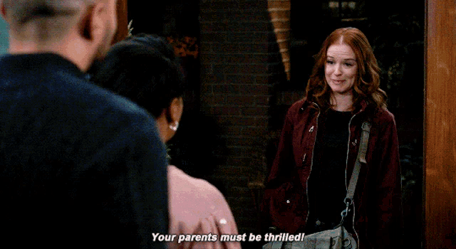 a man is talking to a woman who is laughing and says " your parents must be thrilled "