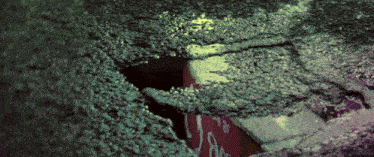 a hole in a concrete wall with a red sign that says " no parking "