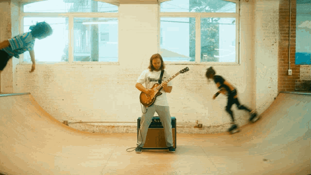 a man playing a guitar in front of an amplifier with the word thrasher on it