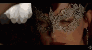 a woman wearing a mask with her eyes closed .