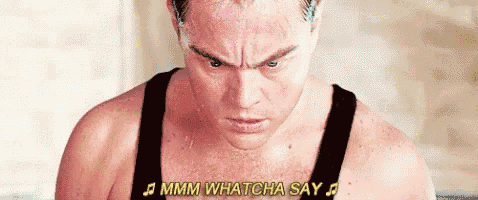 a man in a tank top is sweating and singing a song while sitting in a bathtub .