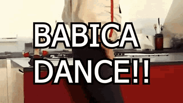 a man is standing in a kitchen with the words babica dance written above him