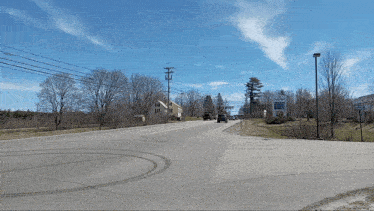 a truck is driving down a road next to a sign that says ' a & r ' on it