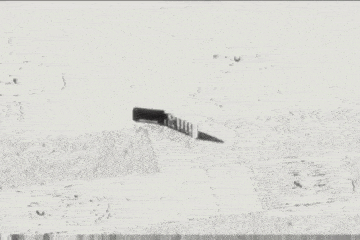 a black and white photo of a phone laying on the ground