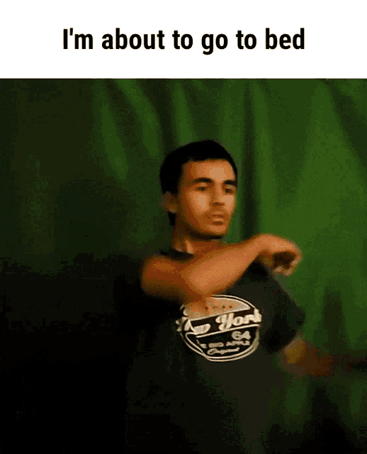a man in a new york shirt is dancing in front of a green screen