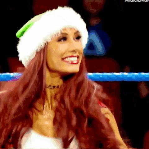 a woman is wearing a santa hat and smiling