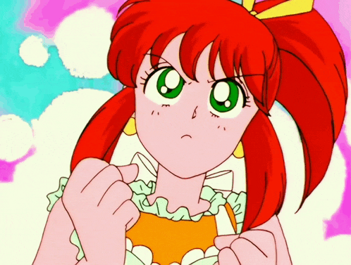a girl with red hair and green eyes is making a face