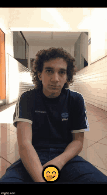 a young man with curly hair wearing a shirt that says pedro kozl