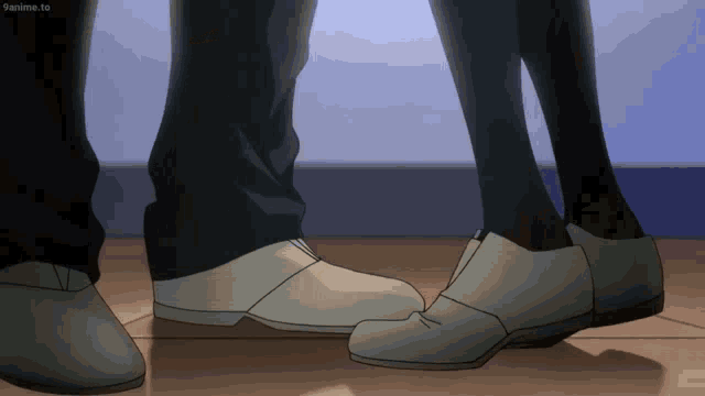 a couple 's feet are standing next to each other and the bottom of their shoes are shown