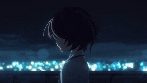 a girl in a ponytail is standing in the dark looking at something .