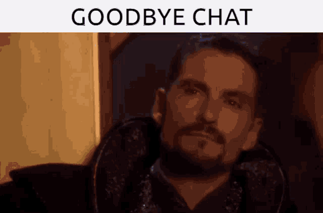 a man with a beard is sitting in a chair with the words goodbye chat above him
