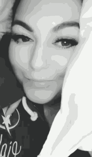 a close up of a woman 's face with a pillow covering her face .